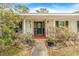 Inviting front entrance with black door, decorative plants, and a brick-paved walkway at 28 W Highbanks Rd, Debary, FL 32713