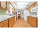Traditional kitchen featuring wooden cabinetry, laminate countertops, and a full suite of appliances at 28 W Highbanks Rd, Debary, FL 32713