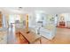 Bright living area with hardwood floors, floral furniture, and views into the dining area at 28 W Highbanks Rd, Debary, FL 32713