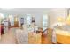 Open-concept living area with hardwood flooring, bright windows, and cozy floral seating at 28 W Highbanks Rd, Debary, FL 32713