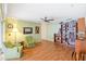 Comfortable living room with hardwood floors, bookshelf, ceiling fan, and armchairs at 28 W Highbanks Rd, Debary, FL 32713