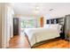 This primary bedroom features wood flooring, patio access and a view of the pool at 28 W Highbanks Rd, Debary, FL 32713