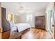 Bright main bedroom with a ceiling fan, wood floors, and ample natural light at 28 W Highbanks Rd, Debary, FL 32713