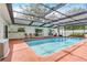 Enclosed pool featuring a patio, seating, and a heater unit at 28 W Highbanks Rd, Debary, FL 32713