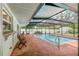 Enclosed pool featuring a patio, seating, and an outdoor storage shed at 28 W Highbanks Rd, Debary, FL 32713