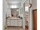 Bathroom with a vanity, large mirror, and view into the toilet and shower room at 29 Ramblewood Trl, Deland, FL 32724