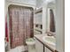 Bathroom featuring a shower with patterned curtain, toilet, and vanity with a light pink countertop at 29 Ramblewood Trl, Deland, FL 32724