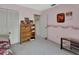 Bedroom with pink walls, floral wallpaper, closet, bookshelf, and desk at 29 Ramblewood Trl, Deland, FL 32724