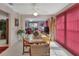 Inviting dining area featuring a wooden table with seating, opening to a living room, and enhanced by natural light at 29 Ramblewood Trl, Deland, FL 32724