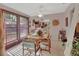 Bright dining area featuring a wooden table with chairs, large windows, and decorative accents for a cozy atmosphere at 29 Ramblewood Trl, Deland, FL 32724