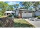 Charming single-story home with stone accents, a two-car garage, and mature landscaping in a quiet neighborhood at 29 Ramblewood Trl, Deland, FL 32724
