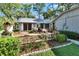 Beautifully landscaped front yard featuring colorful flowers, lush greenery, and a charming one-story home at 29 Ramblewood Trl, Deland, FL 32724