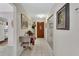 Inviting hallway with tile flooring, decorative paintings, and a view of the front door at 29 Ramblewood Trl, Deland, FL 32724