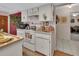 Well-lit kitchen featuring white appliances, cabinets, and an island for food preparation and serving at 29 Ramblewood Trl, Deland, FL 32724