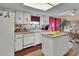 Open kitchen area featuring white cabinets, modern appliances, and a cozy breakfast bar, perfect for casual dining at 29 Ramblewood Trl, Deland, FL 32724