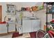 Laundry room with a washer, dryer, utility sink, refrigerator, shelving, and water heater at 29 Ramblewood Trl, Deland, FL 32724