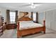 Inviting main bedroom featuring a wooden bed frame, soft lighting, and ample closet space for a relaxing retreat at 29 Ramblewood Trl, Deland, FL 32724