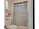 Shower room with a sliding glass door and built in shelving at 29 Ramblewood Trl, Deland, FL 32724