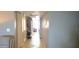 Bright hallway featuring neutral walls, tiled flooring, closet, and decorative wall art at 3003 S Atlantic Ave # 19B4, Daytona Beach, FL 32118
