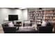 Inviting community library and gathering area with dark leather seating, side tables and large bookshelf at 3003 S Atlantic Ave # 19B4, Daytona Beach, FL 32118