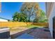 Fenced backyard featuring mature trees, patio area, and lush lawn at 302 Lafayette St, Port Orange, FL 32127