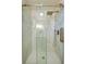 Modern bathroom shower featuring glass doors, rainfall shower head and sleek marble tiling at 302 Lafayette St, Port Orange, FL 32127