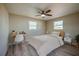 Bright bedroom featuring modern ceiling fan, two windows and staged with desk, chair, bed and nightstand at 302 Lafayette St, Port Orange, FL 32127