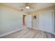 Bedroom with light hardwood floors, a ceiling fan, closet and neutral paint at 302 Lafayette St, Port Orange, FL 32127