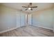 Bedroom with light hardwood floors, a ceiling fan, closet and neutral paint at 302 Lafayette St, Port Orange, FL 32127