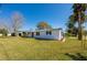 Well-maintained single-story home with a lush green lawn and a tidy landscape, offering a classic curb appeal at 302 Lafayette St, Port Orange, FL 32127