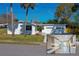 Charming single-story home featuring a clean white exterior, attached garage, and lush lawn at 302 Lafayette St, Port Orange, FL 32127