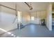 Spacious garage with gray sealed floor, utility sink and access door to home at 302 Lafayette St, Port Orange, FL 32127