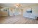 Open living area with wood-look flooring, neutral walls, and natural light, offering a versatile living space at 302 Lafayette St, Port Orange, FL 32127