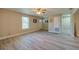 Spacious living room featuring modern flooring, neutral paint, and a ceiling fan, providing comfort and style at 302 Lafayette St, Port Orange, FL 32127