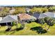 Overhead view of a home surrounded by palm trees, lush landscaping, and other homes in the community at 307 Heron Point Way, Deland, FL 32724