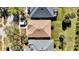 Aerial view of a well-maintained home with a new roof, lush grass, and mature trees at 307 Heron Point Way, Deland, FL 32724