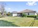 Large, landscaped backyard with lush green grass and view of the home's rear exterior at 307 Heron Point Way, Deland, FL 32724