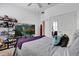 This bedroom is equipped with a ceiling fan, television, dresser, closet, and a bed at 307 Heron Point Way, Deland, FL 32724