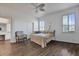 Bright bedroom with wood floors, a ceiling fan, and windows bringing in lots of natural light at 307 Heron Point Way, Deland, FL 32724