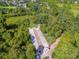 Aerial view of a charming bocce ball court nestled in lush greenery, offering a tranquil recreation spot at 307 Heron Point Way, Deland, FL 32724