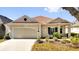Charming single-story home with a well-manicured lawn and attached two-car garage, great curb appeal at 307 Heron Point Way, Deland, FL 32724