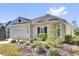 Inviting single-story home with a well-maintained yard featuring lush landscaping at 307 Heron Point Way, Deland, FL 32724