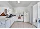 Bright kitchen with white appliances, tile floors, and plenty of cabinet space, ready for meal prep at 307 Heron Point Way, Deland, FL 32724