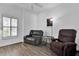 Cozy den with hardwood floors, comfortable seating, and a window with plantation shutters at 307 Heron Point Way, Deland, FL 32724