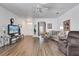 Inviting living room featuring hardwood floors, ceiling fan, and ample space for seating at 307 Heron Point Way, Deland, FL 32724