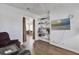 Open living area featuring hardwood floors, a view into the kitchen, and ample shelving at 307 Heron Point Way, Deland, FL 32724