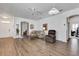 Open-concept living room with hardwood flooring, neutral paint, and ample natural light at 307 Heron Point Way, Deland, FL 32724