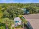 Aerial view of a community splash pad and pool area shaded by trees and equipped with lounge areas and seating at 307 Heron Point Way, Deland, FL 32724