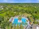 Expansive community pool with palm trees, lounge areas, and beautifully landscaped surroundings, perfect for recreation at 307 Heron Point Way, Deland, FL 32724