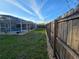 Backyard with a screened in pool and wooden fence for privacy at 3209 S Dorchester Dr, Deltona, FL 32738